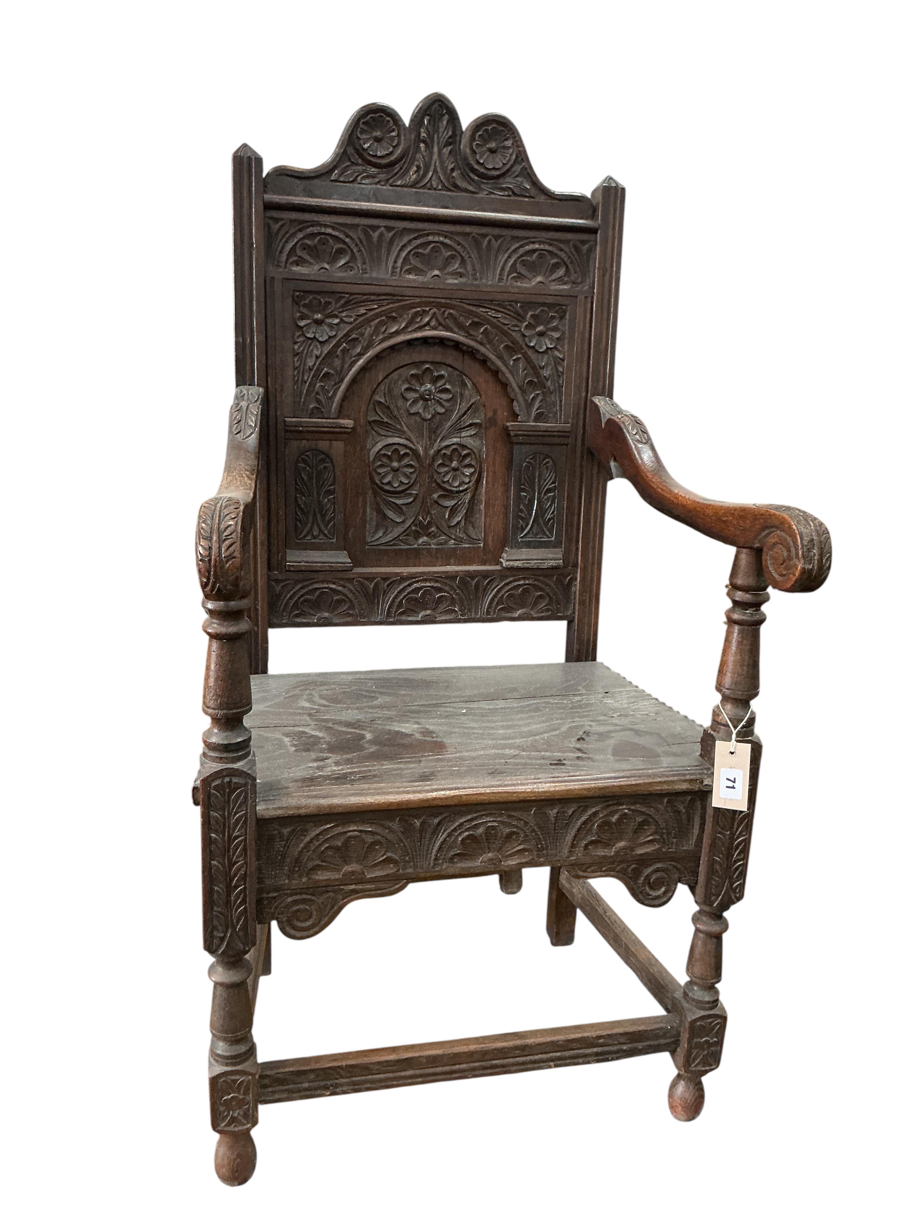 An 18th century style carved oak wainscot chair, width 57cm, depth 43cm, height 120cm